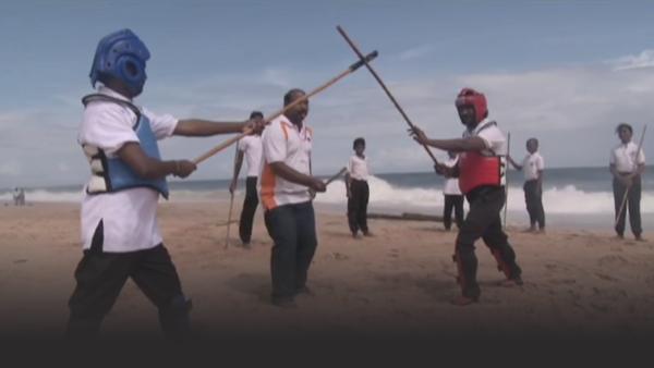Silambam stick fighting on the beach