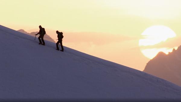 People climbing a snowy mountain