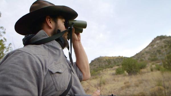 Man looking into binoculars