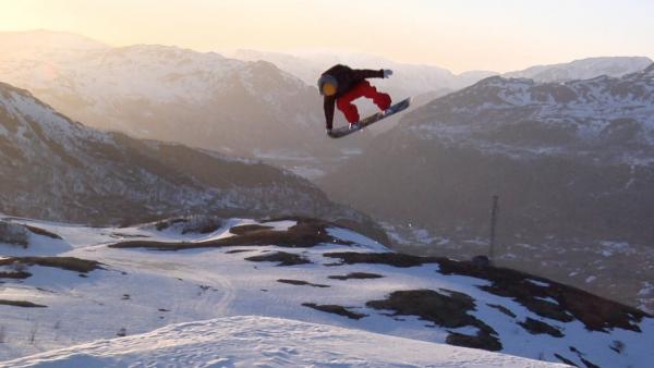 snowboarder grabbing tail of board suspended mid-air