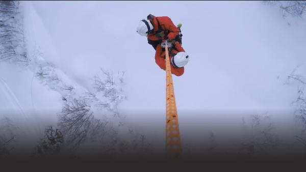 People are lowered from a helicopter