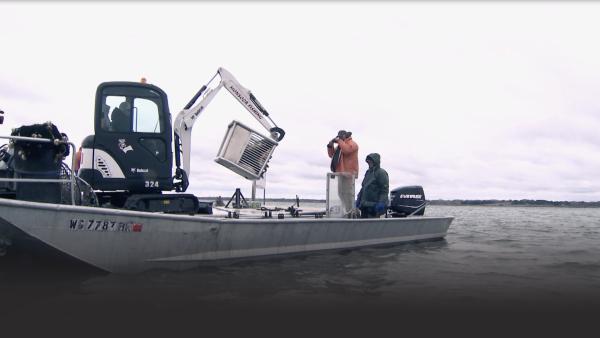 Three men work by their boat.