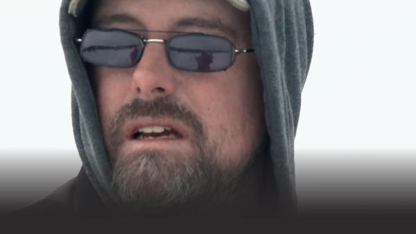 A man looks at the water.