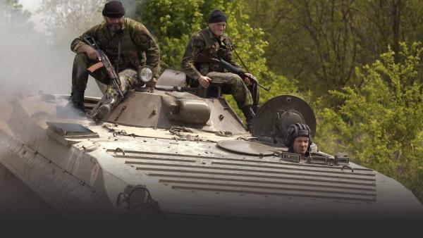 Men riding in a tank