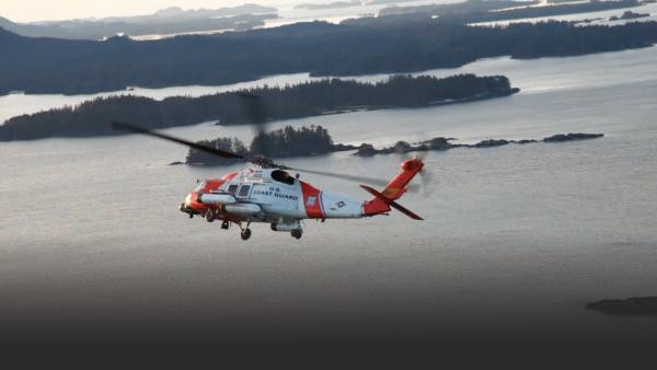 Helicopter flying by water
