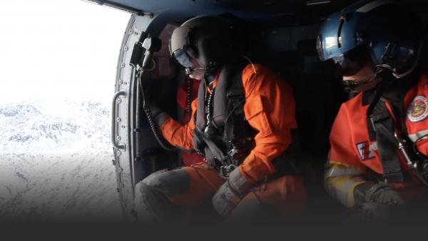 Two people flying in a helicopter