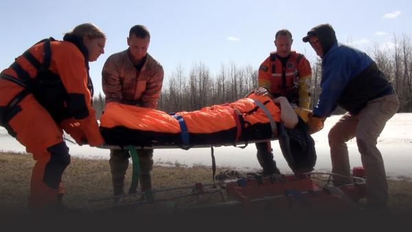 People carrying a man on a stretcher