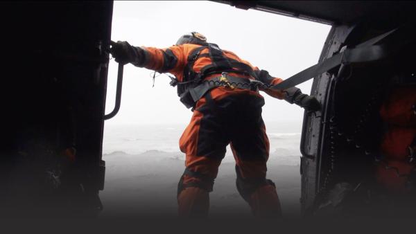 Man leaning out of a helicopter