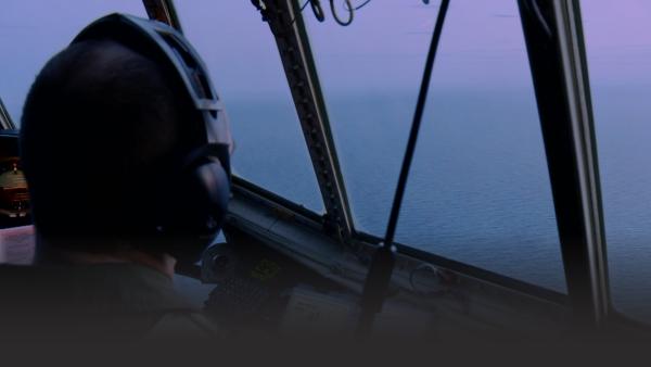 Man looking out of a helicopter