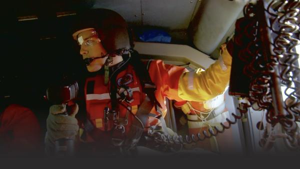 A pilot in a helicopter.