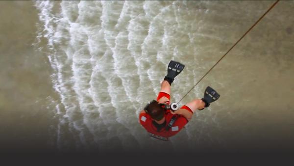 Coast Guard Florida helicopter lowering swimmer to water