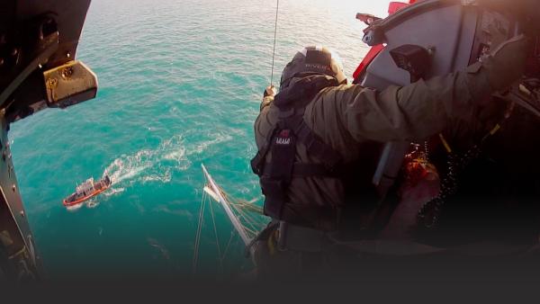 Coast Guard helicopter over a ship