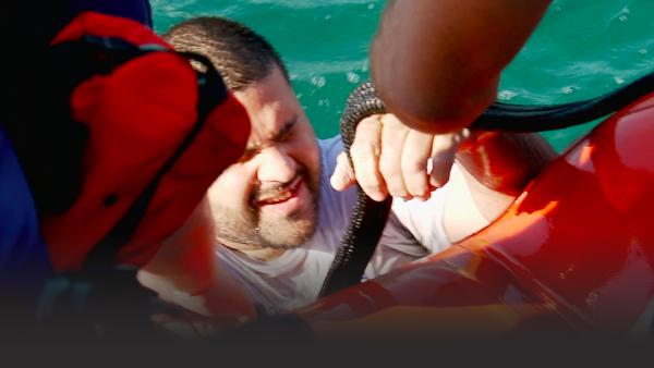 Man being pulled into a boat