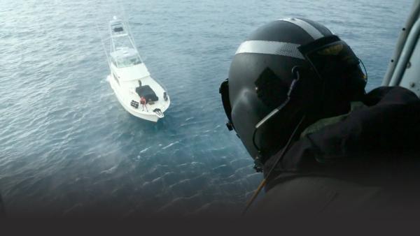 Coast Guardsman looks down on a boat
