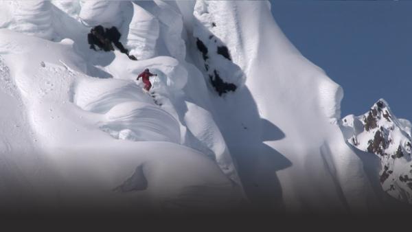 Man skiing down vertical drop