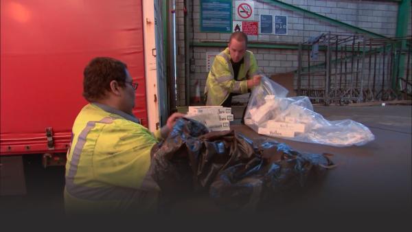 Custom officers taking away the driver's illegal tobacco. 