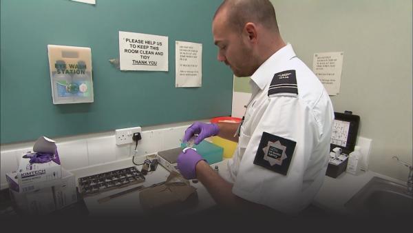 Customs officer performing drug tests. 