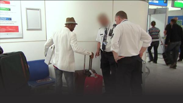 A suspicious man holding a suitcase thats not his. 