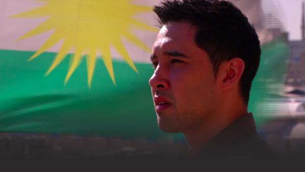 Man in front of Iraqi flag