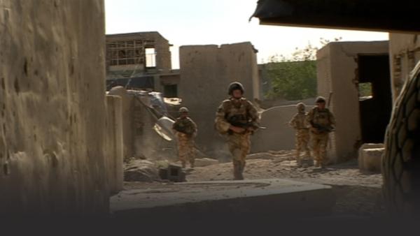 Soldiers walking through bombed buildings in Afghanistan
