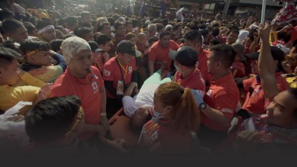 Crowd of people with someone on a stretcher