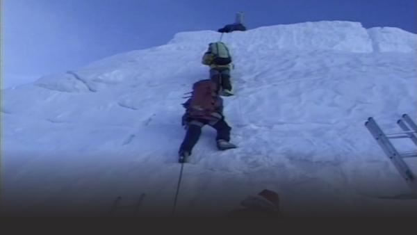 Man climbing snowy mountain