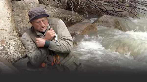 Man shivering in river water
