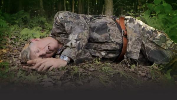Man lying on ground exhausted