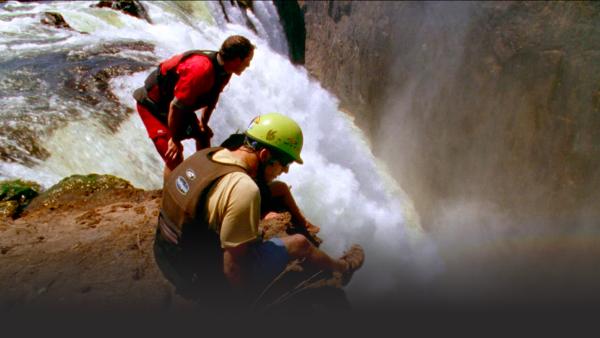 Kayakers at a waterfall