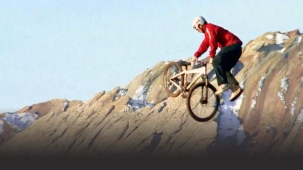 Mountain biker attempting a trick.
