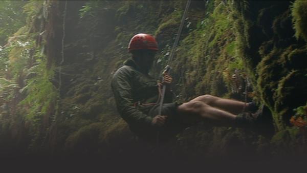 Man rappelling down the side of a cliff in Low's Gully