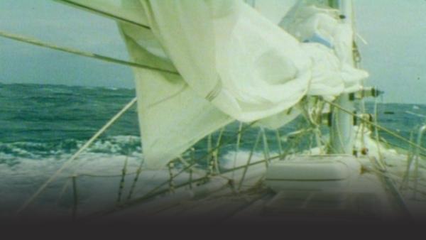 Sailboat sailing through rough ocean 