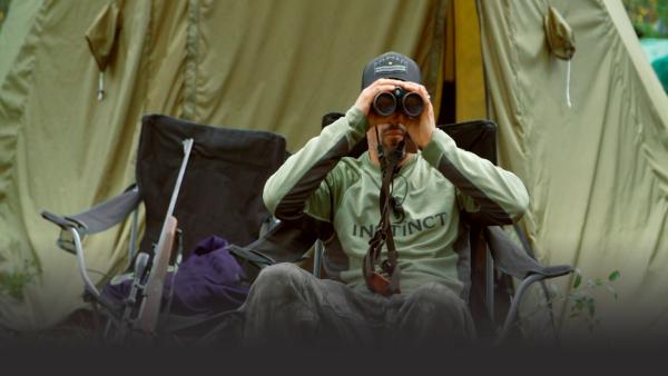 Man watching through binoculars