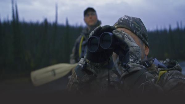 Man looking through binoculars 