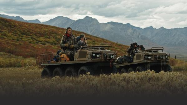 Men in trucks surveying the land
