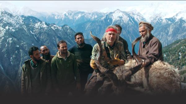 Man with guides and Markhor sheep