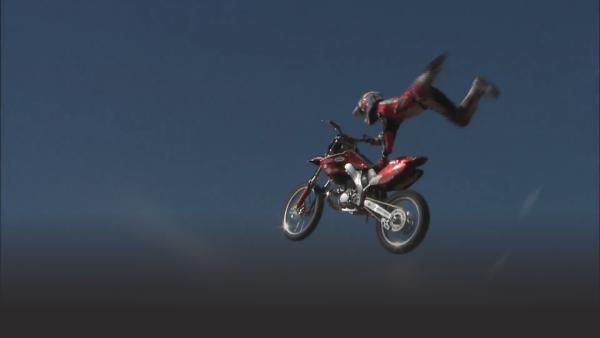 Dave Demangos soaring through the air as he performs his superman stunt