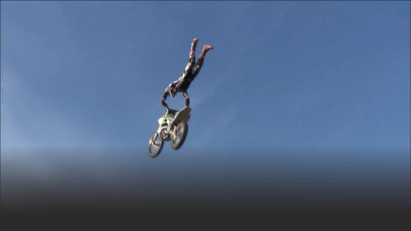 Drake McElroy with his legs in the air 
