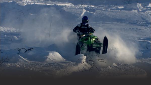 Snowmobiler races down mountain