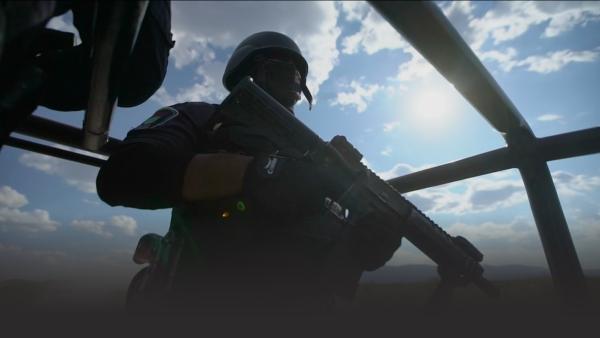 Policeman on a jeep with a machine gun