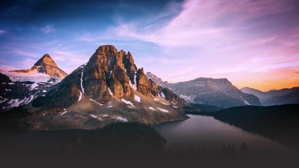 Mountain appears in front of a sunset.