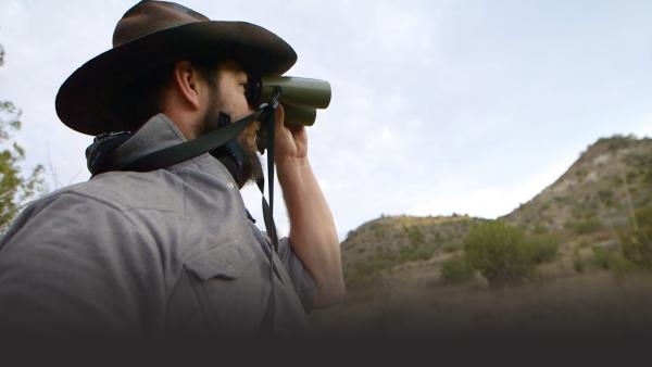 Man looking into binoculars