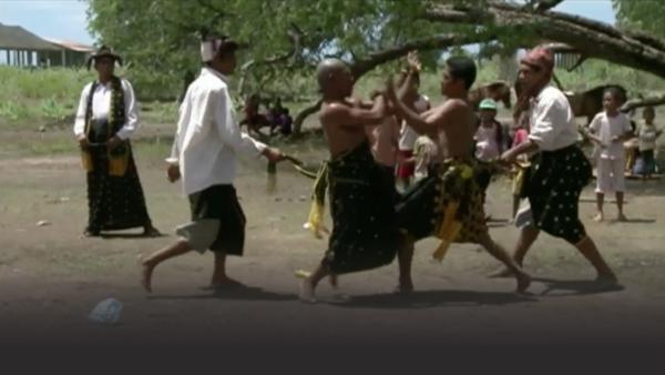 Two men competing in the blood sport of Embela