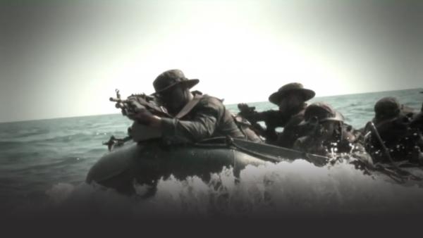 Thai marines with guns on small boats in the ocean 