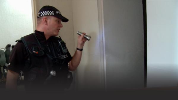 Border officer peers into a room